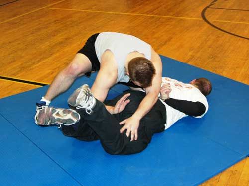 Two officers participate in a grappling training exercise