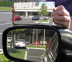 A standard left side mirror is at the top of the photo, with the Hicks design at the bottom.