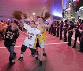 Officers of the Los Angeles Police Department form a line as fans celebrate the Lakers' victory in the NBA Championship. (AP Photo/Jae C. Hong)