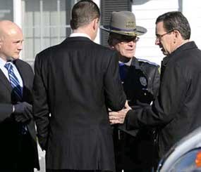 Gov. Dannel P. Malloy, right, talks with officials at a staging area in Newtown.