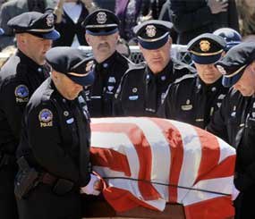 Greenland police carry the body of their chief during a memorial service for Police Chief Michael Maloney, on Thursday, April 19, 2012 in Hampton, N.H. Maloney was days away from retirement when he was fatally shot last Thursday. He and other officers were trying to serve a warrant.