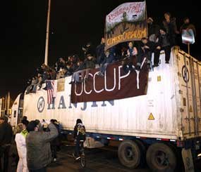 Protestors sit on top of a container truck after blocking the Port of Oakland (Calif.) in mid-December 2011. Occupy protesters shut down the Port of Oakland — the fifth busiest container port in the United States — disrupting the supply chain of countless manufacturers well past the time when the last protester finally went home.