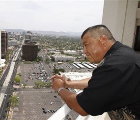 Phoenix police officer David Salgado looks out over the Phoenix skyline Monday, May 17, 2010. Salgado, an opponent of the new immigration law in Arizona, has sued the city of Phoenix and the governor over the measure.