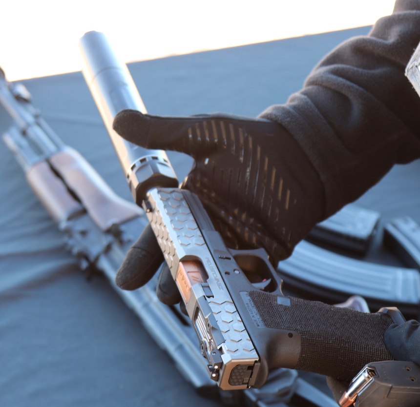 Dead Air had a Glock with a ZEV custom slide and flip up sights, a collaboration between K+S Precision and Dead Air Armament. With the suppressor attached, the user flips up the taller version of the sights. They are flipped down when the suppressor is not attached. They maintained the same zero flipped up or down.