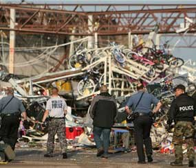 Police officers walk in to the back of a destroyed store in Joplin (Mo.), where scores were killed and hundreds more injured when a tornado cut a destructive path through the town Sunday evening. (AP Photo)