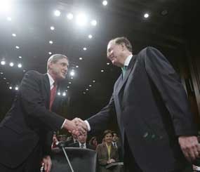 Sen. Jay Rockefeller (right), greets FBI Director Robert Mueller on Capitol Hill prior to the start of a 2007 hearing on national threats. (AP Photo)