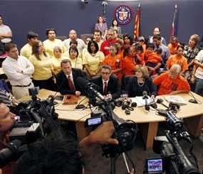 Calling for Maricopa County Sheriff Joe Arpaio to resign are critics seated from left to right, attorney Chad Snow, Randy Parraz, co-founder of Maricopa Citizens for Safety and Accountability, Maricopa County Board of Supervisors member Mary Rose Wilcox, and local activist Salvador Reza, during a news conference at the Maricopa County Board of Supervisors chambers Wednesday, May 11, 2011, in Phoenix. Critics gathered and called for the resignation of Maricopa County Sheriff Joe Arpaio while asking the U.S. Attorney's Office to place the sheriff's office into receivership. Arpaio's opponents are critical of nearly $100 million in misspent funds by his agency over eight years and a recent internal investigation that found mismanagement by his top commanders.