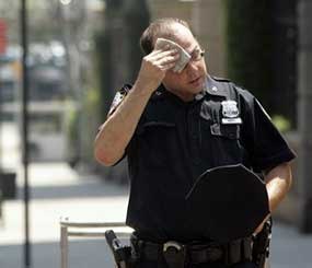 A New York City police officer wipes his face next during an August 2006 heat wave in New York.