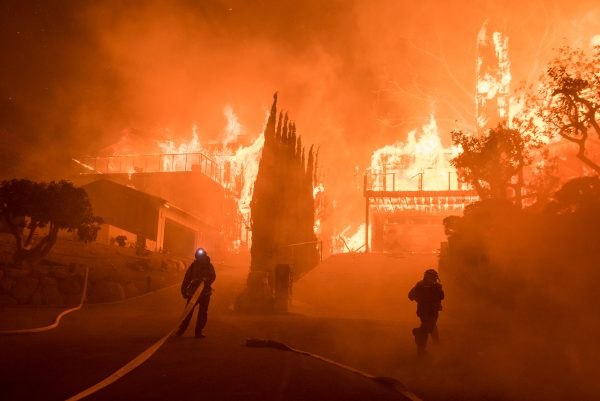 Structures burn as firefighters work to contain the massive wildfire. (Photo/R. Cullom)
