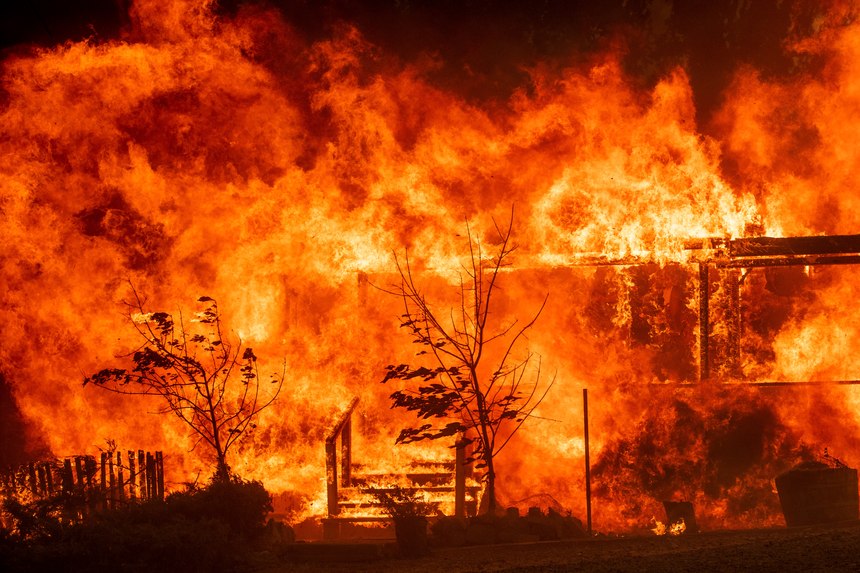 Flames consume a home as the River Fire tears though Lakeport, Calif.