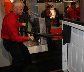 Sandy Wall, a 28-year veteran of the Houston Police Department, demonstrates the breaching device he invented.