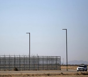 In this Jan. 20, 2016 file photo, an unmarked police truck patrols the outside of a private detention center operated by CoreCivic in Eloy, Ariz. (AP Photo/Ricardo Arduengo, File)
