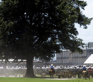 In this Aug. 10, 2009, file photo, prisoners ride wagons from their jobs in agricultural fields surrounding the Cummins and Varner units of the Arkansas Department of Correction complex near Varner, Ark.
