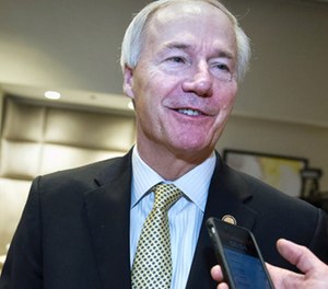 In this Feb. 25, 2017, file photo, Arkansas Gov. Asa Hutchinson speaks with a reporter in Washington.
