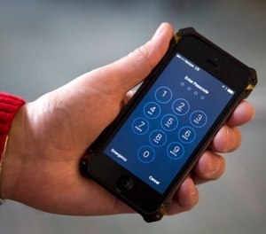 In this Feb. 17, 2016, file photo an iPhone is seen in Washington. (AP Photo/Carolyn Kaster, File)