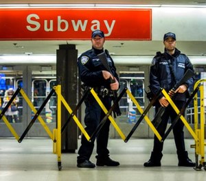 Police stand guard inside the Port Authority Bus Terminal following an explosion near Times Square on Monday, Dec. 11, 2017, in New York. (AP Photo/Andres Kudacki)