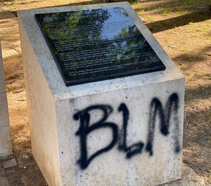 BLM was painted on stone markers and sidewalks at the Peace Officers Memorial.