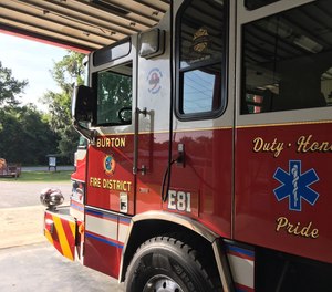 A man was arrested and charged with third degree assault and battery after allegedly coughing on a Burton Fire District firefighter.