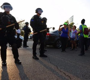 St. Louis County police say they broke up a demonstration near an upscale mall because protesters weren't listening to instructions and tried to evade two lines of officers blocking the on-ramp to a highway, Wednesday, Sept. 20, 2017, in St. Louis.