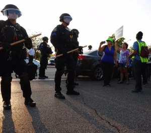 St. Louis County police say they broke up a demonstration near an upscale mall because protesters weren't listening to instructions and tried to evade two lines of officers blocking the on-ramp to a highway, Wednesday, Sept. 20, 2017, in St. Louis.