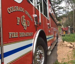 Colorado Springs firefighters approached a vehicle with possible overdose victims inside, but the driver of the vehicle rammed into the fire truck after crews backed away when they spotted a gun.