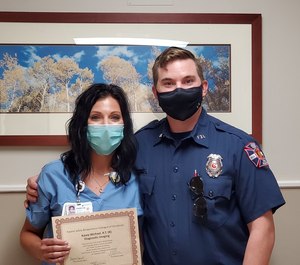 North Suburban Medical Center X-ray Technician Kasey Wichael stands with Adams County Fire Rescue Paramedic Cody Grove at a ceremony where Wichael was named the hospital's Patient Safety Colleague of the Month. Grove wrote a letter that made its way to the hospital CEO after witnessing Wichael save a child's life in the emergency department.
