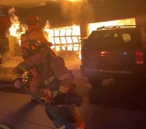 A three-bay garage fire was well-involved and venting through the roof of the building when members arrived on scene.