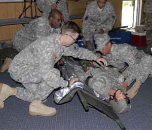 Soldiers learn combat casualty care and how to apply a tourniquet. (Photo by Army National Guard Sgt. Ruth McClary)