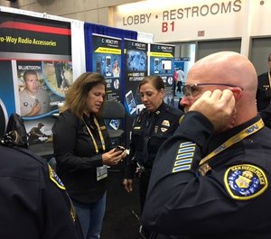 You can feel and hear the difference of these earpieces. An officer tries out Earphone Connection at a trade show.