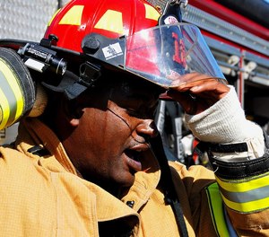 A firefighter removes his helmet after the completion of an exercise at Dobbins Air Reserve Base, Ga.