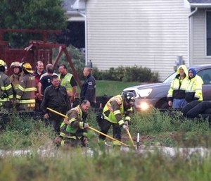 A boy was rescued from a storm sewer after a firefighter spotted his finger poking out of a manhole cover. (Photo/AP)