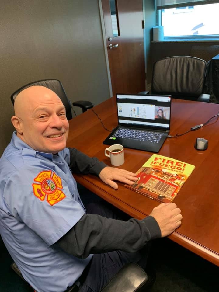 Perth Amboy Firefighter RL Anderson, a retired principal, prepares to read to students for Read Across America Day.