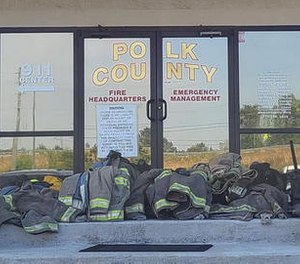 A group of volunteer firefighters in Georgia turned in their gear Tuesday to protest the termination of the county's fire chief.
