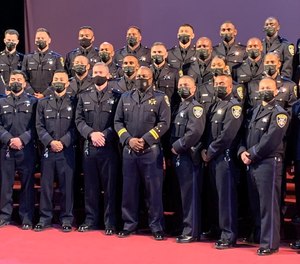 New Oakland police officers graduate from the police academy on May 28, 2021.