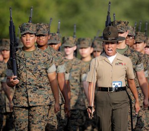 Marine Corps Staff Sgt. Ashlin Kohus, a drill instructor, gives a command during a final drill test at Marine Corps Recruit Depot Parris Island, S.C., July 10, 2019.