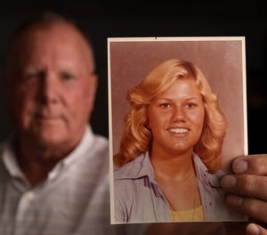Jack Fleischli holds a photo of his sister, Ginger, when she 17. She was murdered at age 20.