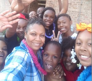 Officer Jennifer Maddox with some of the Future Ties children