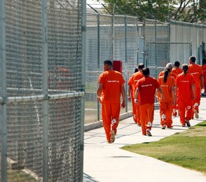 Inmates walk through the yard at the Lerdo jail facility in Bakersfield in 2014.
