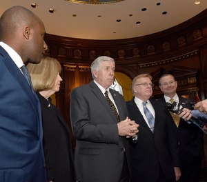 Governor Mike Parson, center, takes questions from the media with, from left, Kansas City Mayor Quinton Lucas, St. Louis Mayor Lyda Krewson, Parson, Springfield Mayor Ken McClure and Columbia Mayor Brian Treece at the Governor's Office in the Capitol building.