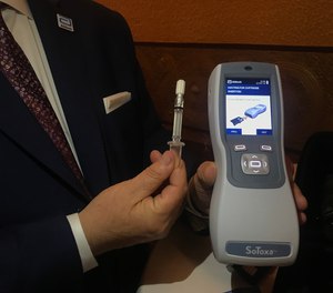 Fred Delfino, a law enforcement liaison with Abbott Toxicology, exhibits the saliva collection device being used by Michigan police to conduct roadside tests for drugged driving.