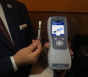 Fred Delfino, a law enforcement liaison with Abbott Toxicology, exhibits the saliva collection device being used by Michigan police to conduct roadside tests for drugged driving.