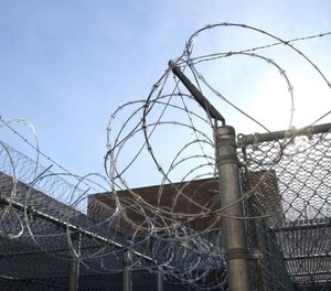 Wire surrounds the top of the fence around an exercise yard at the Adult Correctional Institutions in Cranston, Rhode Island.