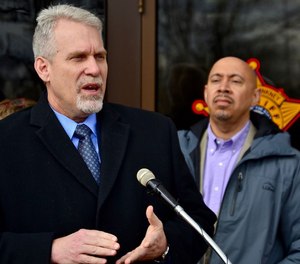 The county's former director of corrections, Ken Mills, speaks as Cuyahoga County Sheriff Cliff Pinkney looks on at an April 2018 news conference.