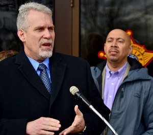 The county's former director of corrections, Ken Mills, speaks as Cuyahoga County Sheriff Cliff Pinkney looks on at an April 2018 news conference.