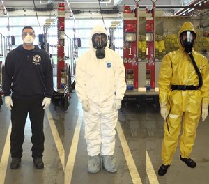 In March, Portland Fire & Rescue firefighters moved to the full air filter mask, as worn by the firefighter in the white suit, on medical calls when firefighters have close encounters with a potential patient. They wear the yellow suit when they suspect someone has coronavirus symptoms.