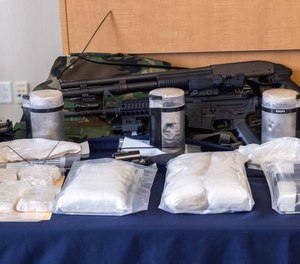 Packets of seized heroin, cocaine, fentanyl and firearms were on display as Hampden District Attorney Anthony Gulluni held a press conference on Wednesday to describe multi-agency efforts to dismantle a major drug trafficking organization.