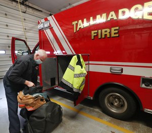 Tallmadge Firefighter-Medic David Lee loads his turnout gear into a med unit as he starts his shift. About 60% of Tallmadge Fire Department employees have gotten the first dose of the COVID-19 vaccine. In all of Summit County, only about 40% of EMS providers have opted in to receive the first dose.