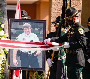 A flag folding ceremony is held during funeral services for Master Cpl. Brian LaVigne at Idlewild Baptist Church in Lutz.