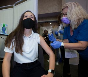 Cranford First Aid Squad Volunteer Kelsey Quinones, 16, receives her COVID-19 vaccine at CentraState Healthcare System by Nurse Manager Lisa Kaiser on Jan. 26, 2021. Quinones received the Pfizer vaccine, the only COVID-19 vaccine approved for those under 18, after a month-long search.