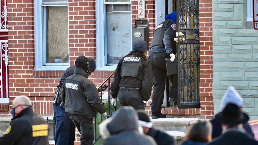 Authorities enter a home in West Baltimore where a U.S. Marshal was shot attempting to serve an arrest warrant.